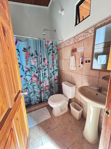 a bathroom with a toilet and a sink at Point Break Santa Teresa in Santa Teresa Beach