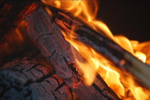 a close up of a fire in an oven at Readers Field Glamping in Great Sampford