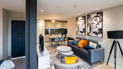 a living room with a couch and a table at Mega5 Modern 2Bedroom Luxury Apartment Deansgate-2baths, 2toilets, with car park in Manchester