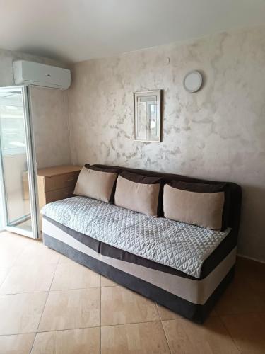 a bed with two pillows in a room at Zevs Apartmani 2 in Igalo