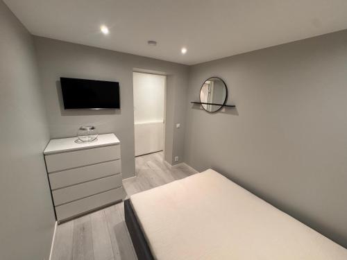 a bedroom with a bed and a flat screen tv at Borre in Horten