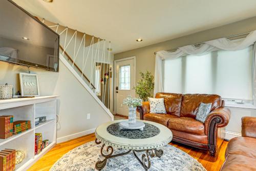 a living room with a couch and a table at Lakefront Cottage 2 Mi to Palladium in Worcester! in Worcester