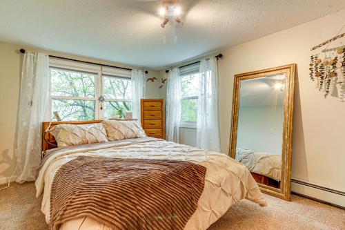 a bedroom with a bed and a mirror at Lakefront Cottage 2 Mi to Palladium in Worcester! in Worcester