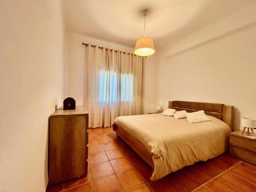 a bedroom with a large bed and a window at Cabo garden in Cabo Negro