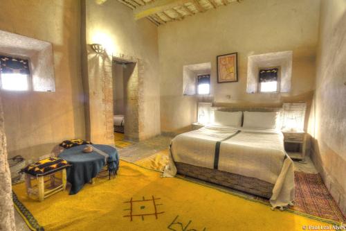 a bedroom with a large bed in a room at Kasbah Baha Baha in Nkob
