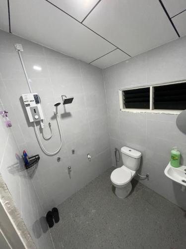 a bathroom with a toilet and a sink at Nuri Homestay Rusila 2 in Kuala Terengganu