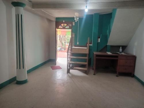 a room with a desk and a table and a door at casa los patos in Oaxaca City