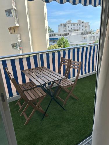 a bench and a chair on a balcony at Riviera Retreat - Steps to Beach & Shops, Balcony & AC in Saint-Laurent-du-Var