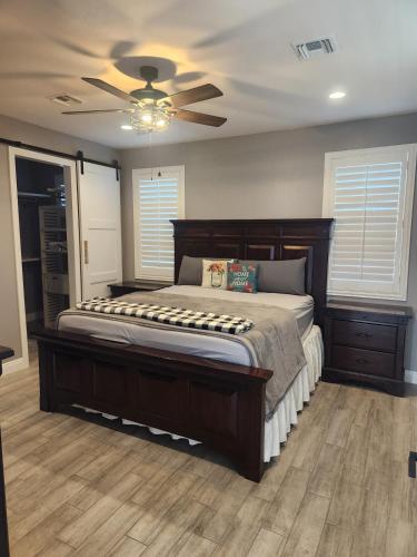 a bedroom with a large bed with a ceiling fan at Modern Apartment in The Groves in Mesa