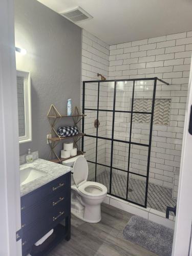 a bathroom with a toilet and a sink at Modern Apartment in The Groves in Mesa