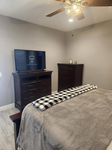 a bedroom with a bed and a flat screen tv at Modern Apartment in The Groves in Mesa