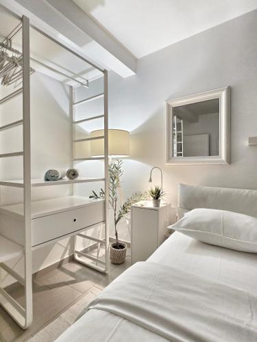 a white bedroom with a bed and a desk at SeaHouse by Jelena in Bibinje