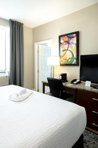 a hotel room with a bed and a desk at Quality Inn & Suites in Vancouver