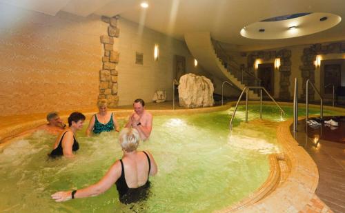 a group of people in a hot tub in a spa at Fehérvár Cappuccino apartman City center, AC, Easy Parking in Székesfehérvár