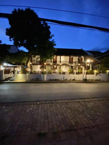 an empty street with a building at night at Luang Prabang Golden Lotus Villa River View in Luang Prabang