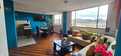 a living room with a couch and a table in it at Mirador Calle Larga - anti-ruido in Cuenca