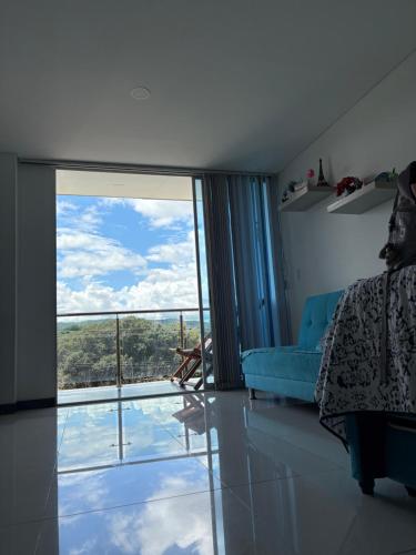 a living room with a large sliding glass door at Lindo Apartaestudio in Ricaurte
