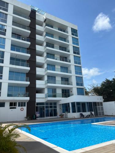 a large apartment building with a swimming pool at Lindo Apartaestudio in Ricaurte