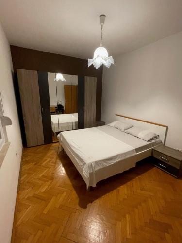 a bedroom with a large bed and a mirror at Apartments with parking space Seget Vranjica, Trogir - 12760 in Donji Seget