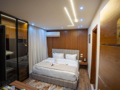 a bedroom with a large bed in a room at Tuya pyramids hotel in Cairo