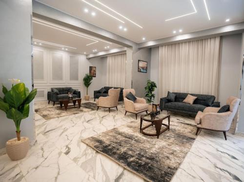 a large living room with couches and chairs at Tuya pyramids hotel in Cairo