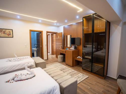 a hotel room with two beds and a bathroom at Tuya pyramids hotel in Cairo
