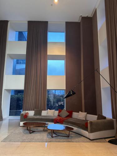 a living room with two couches in front of a large window at Foster Yacht Suites in Buenos Aires