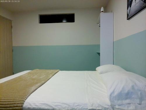Ένα ή περισσότερα κρεβάτια σε δωμάτιο στο Hotel HIH