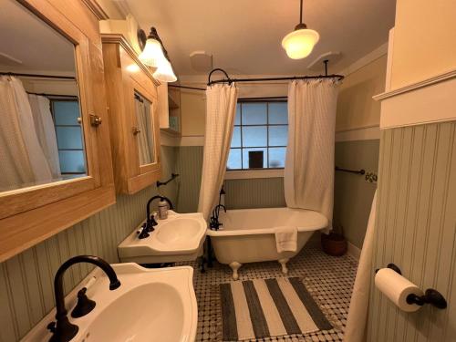 a bathroom with a tub and a sink and a tub at Beach Haven Belle -OI Collection in Beach Haven