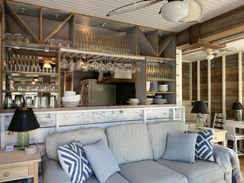 a living room with a couch and a bar at Beach Haven Belle -OI Collection in Beach Haven