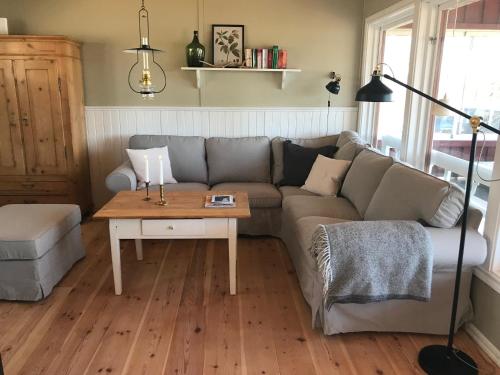 a living room with a couch and a table at Hus Bjöksjöblick in Hällefors
