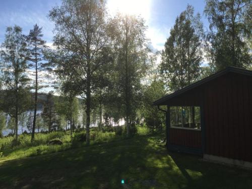 a cabin with a view of a lake and trees at Hus Bjöksjöblick in Hällefors