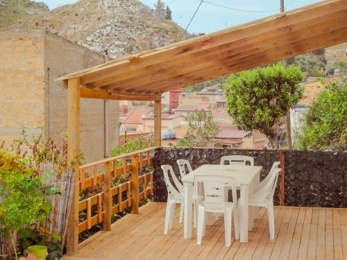a white table and chairs on a wooden deck at Villa il Giglio in Montallegro