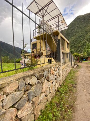a building on top of a stone wall at Tumi Lodge in Colcapampa