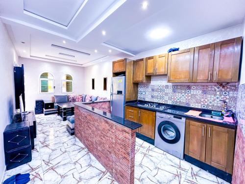a kitchen with a washer and dryer in a room at Complexe touristique City Center Oued Laou - Pool & Play area in Oued Laou