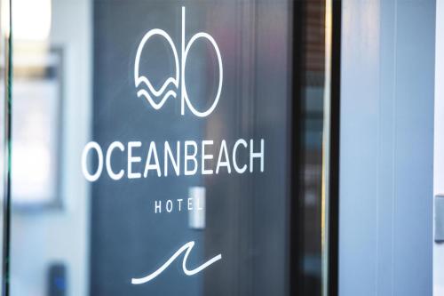 a sign on a door of an ocean beach hotel at Nightcap at Ocean Beach Hotel in Umina