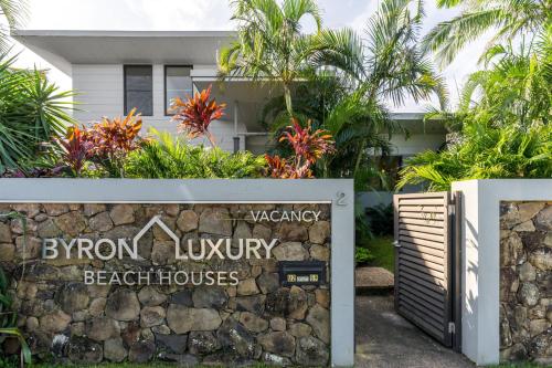 a sign for the entrance to the beach house at Byron Lux Beach Houses in Byron Bay