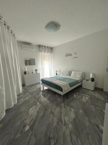 a white bedroom with a bed and a window at Arcola -La Spezia-cinque terre-Lerici in Arcola