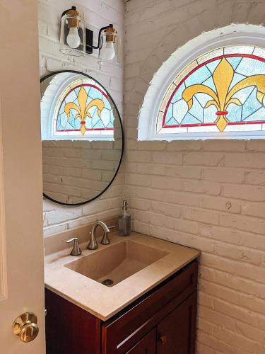 a bathroom with a sink and two stained glass windows at Captains Courtyard - Heart of Historic Downtown Wilmington - 48 Firepit - Turf Yard in Wilmington
