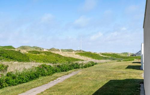 a path through the grass next to a house at Nice Apartment In Vestervig With Sauna in Vestervig