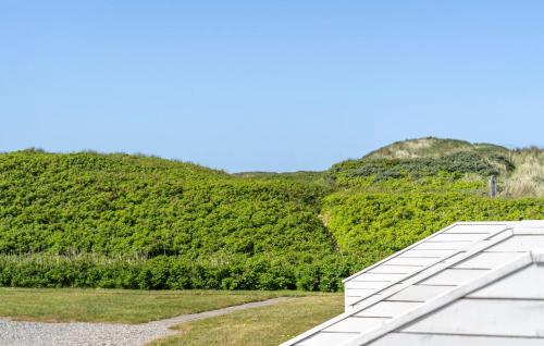 a roof of a building in front of a mountain at Nice Apartment In Vestervig With Sauna in Vestervig