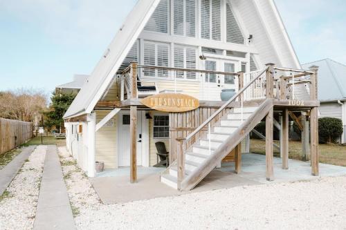 a house with a staircase in front of it at Late Summer Specials - 2 blocks to Beach - Backyard - Walk to Boardwalk in Carolina Beach