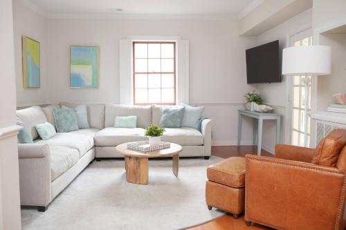 a living room with a couch and a table at 48" Gas Firepit - Historic DT - Late Summer Specials - Steps to Riverwalk in Wilmington