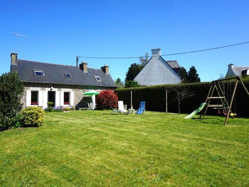 a yard with a house and a playground at House in Brittany near Petit Havre Beach in Pordic