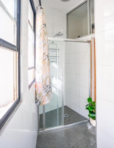 a shower with a glass door in a bathroom at Mad Monkey Kings Cross in Sydney