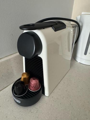 a toaster sitting on a counter with someones hat at Busselton Gale Street Motel & Villas in Busselton