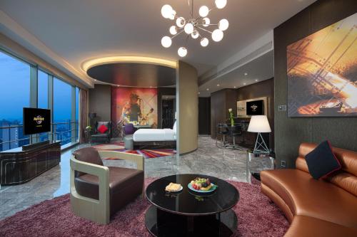 a living room with a couch and a room with a bed at Hard Rock Hotel Shenzhen in Shenzhen