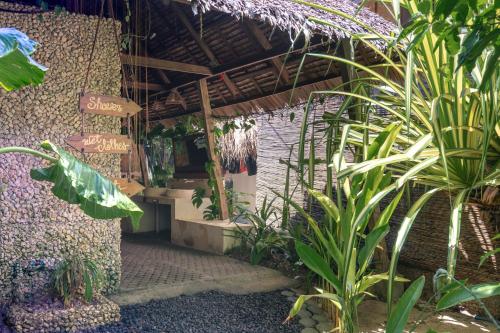 a garden with many plants and a building at Soffta Surf Ranch in General Luna