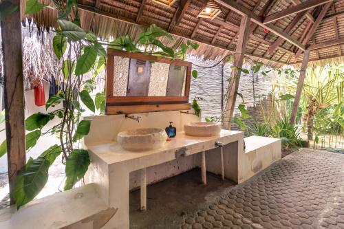 a bathroom with two sinks and a mirror at Soffta Surf Ranch in General Luna