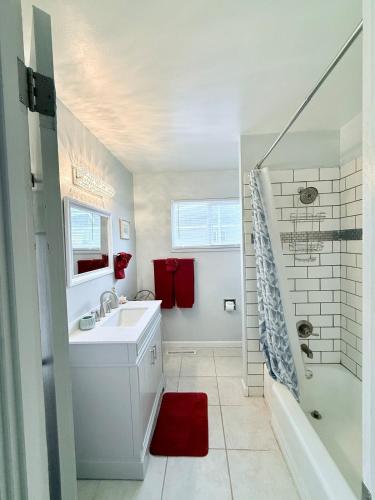 a white bathroom with a sink and a shower at Comfortable Family Getaway! in Cheyenne